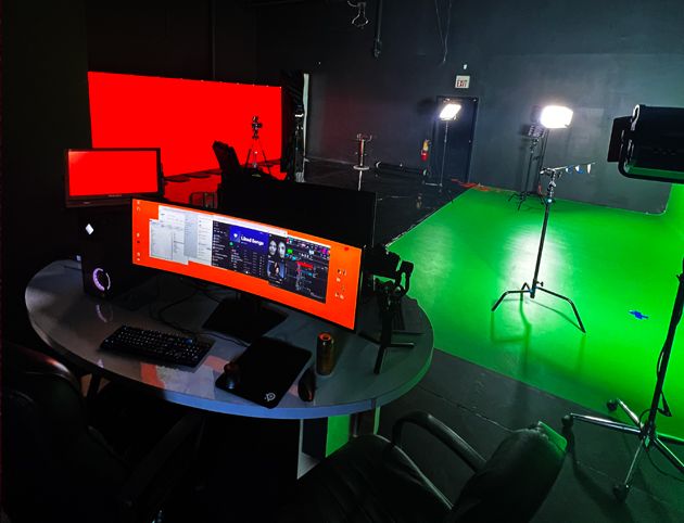 Studio setup with green screen and monitoring station